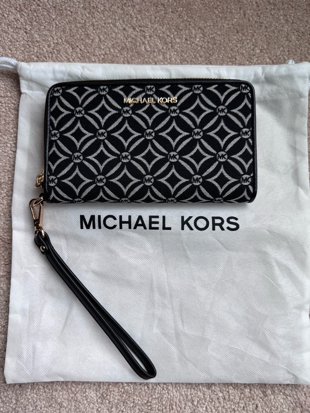 Michael Kors Large Flat phone case wallet in a black jacquard logo pattern.